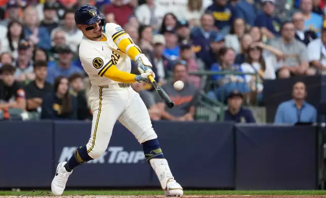 Milwaukee Brewers' William Contreras hits an RBI sacrifice fly during the second inning of a baseball game against the San Francisco Giants, Monday, June 1, 2026, in Milwaukee. (AP Photo/Aaron Gash)