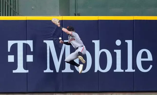 San Francisco Giants' Jonah Cox is unable to catch a ball hit by Milwaukee Brewers' Brice Turang during the second inning of a baseball game Monday, June 1, 2026, in Milwaukee. (AP Photo/Aaron Gash)