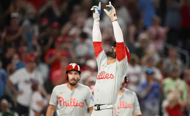 Philadelphia Phillies' Derek Hill celebrates his two-run home run with during the ninth inning of a baseball game against the Washington Nationals, Wednesday, June 24, 2026, in Washington. (AP Photo/Nick Wass)