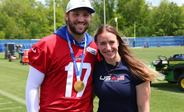 Buffalo Bills quarterback Josh Allen (17) and women's ice hockey gold medalist Hayley Scamurra pose following an NFL football practice in Orchard Park, N.Y., Tuesday, June 2, 2026. (AP Photo/Jeffrey T. Barnes)