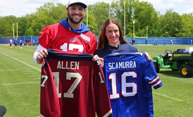 Buffalo Bills quarterback Josh Allen (17) and women's ice hockey gold medalist Hayley Scamurra pose following an NFL football practice in Orchard Park, N.Y., Tuesday, June 2, 2026. (AP Photo/Jeffrey T. Barnes)