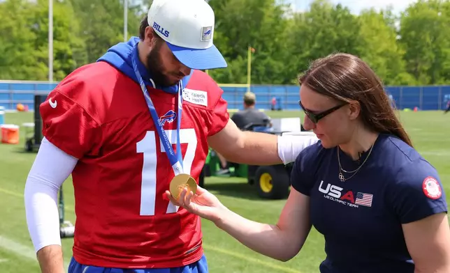 Buffalo Bills quarterback Josh Allen (17) and women's ice hockey gold medalist Hayley Scamurra talk following an NFL football practice in Orchard Park, N.Y., Tuesday, June 2, 2026. (AP Photo/Jeffrey T. Barnes)