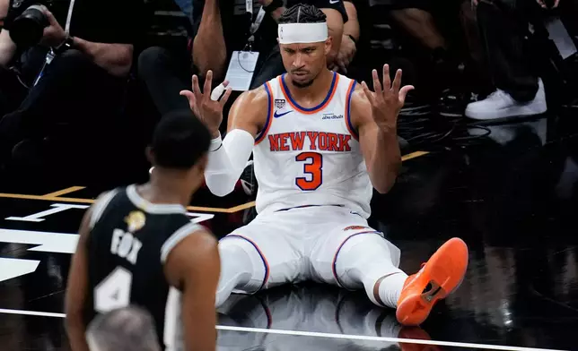 New York Knicks guard Josh Hart (3) looks towards San Antonio Spurs guard De'aaron Fox (4) after a foul during the second half of Game 1 of the NBA Finals basketball series, Wednesday, June 3, 2026, in San Antonio. (AP Photo/David J. Phillip)