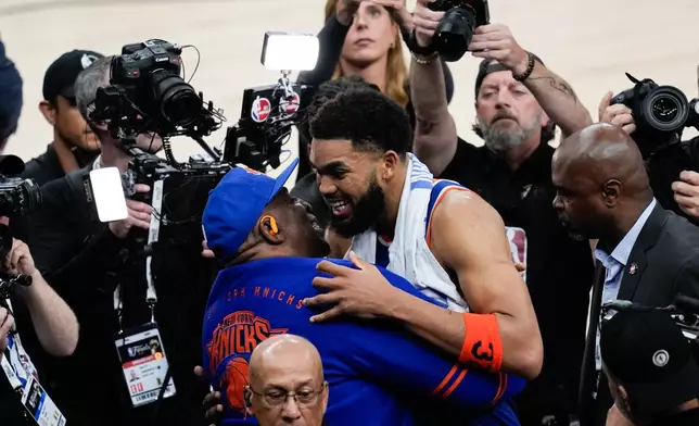New York Knicks center Karl-Anthony Towns hugs his dad, Karl-Anthony Towns Sr., after Game 2 of the NBA Finals basketball series against the San Antonio Spurs, Friday, June 5, 2026, in San Antonio. (AP Photo/David J. Phillip)