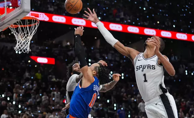 San Antonio Spurs forward Victor Wembanyama (1) blocks the shot of New York Knicks guard Jalen Brunson (11) during the second half of Game 2 of the NBA Finals basketball series, Friday, June 5, 2026, in San Antonio. (AP Photo/Eric Gay)