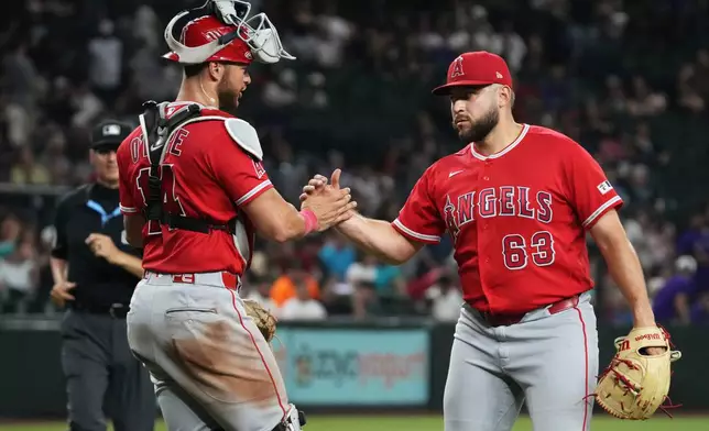 Los Angeles Angels catcher Logan O'Hoppe (14) and pitcher Chase Silseth celebrate after defeating the Arizona Diamondbacks a baseball game, Tuesday, June 16, 2026, in Phoenix. (AP Photo/Rick Scuteri)