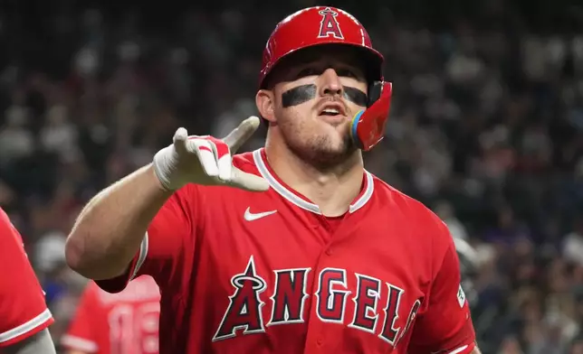 Los Angeles Angels' Mike Trout (27) reacts after hitting a two-run home run against the Arizona Diamondbacks in the fifth inning of a baseball game, Tuesday, June 16, 2026, in Phoenix. (AP Photo/Rick Scuteri)