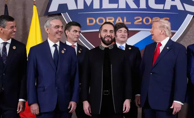 FILE - President Donald Trump poses for a group photo with, from left, Paraguay President Santiago Peña, Dominican Republic President Luis Abinader, Bolivia President Rodrigo Paz Pereira, El Salvador President Nayib Bukele, and Argentina President Javier Milei, at the Shield of the Americas Summit at Trump National Doral Miami in Doral, Fla., March 7, 2026. (AP Photo/Mark Schiefelbein, File)