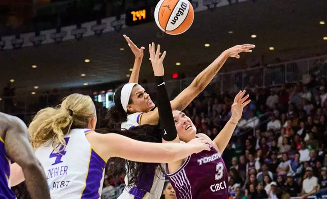 Toronto Tempo's Marina Mabrey (3) and Los Angeles Sparks' Rae Burrell, second from front right, vie for control of the ball during the first half of a WNBA basketball game in Toronto, Thursday, June 25, 2026. (Sammy Kogan/The Canadian Press via AP)