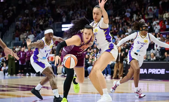 Toronto Tempo's Marina Mabrey, center left, drives past Los Angeles Sparks' Dearica Hamby, center right, during the first half of a WNBA basketball game in Toronto, Thursday, June 25, 2026. (Sammy Kogan/The Canadian Press via AP)