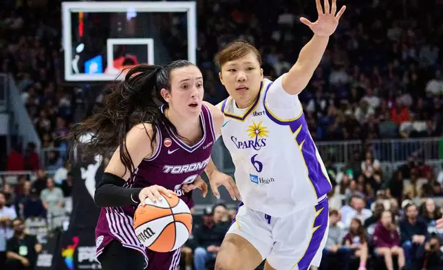 Toronto Tempo's Marina Mabrey (3) drives to the net past Los Angeles Sparks' Jihyun Park (6) during the first half of WNBA basketball game in Toronto, Thursday, June 25, 2026. (Sammy Kogan/The Canadian Press via AP)