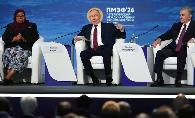 Russian President Vladimir Putin, center, speaks as Tanzanian President Samia Suluhu Hassan, left, and Uzbekistan's President Shavkat Mirziyoyev sit near during a plenary session at the St. Petersburg International Economic Forum in St. Petersburg, Russia, on Friday, June 5, 2026. (AP Photo/Dmitri Lovetsky)
