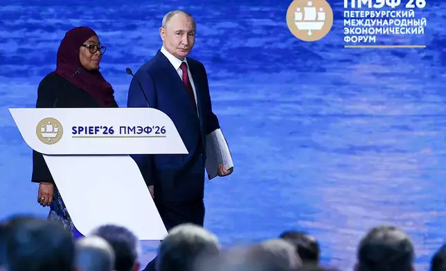 In this photo released by the Roscongress Foundation, Russian President Vladimir Putin, center, and Tanzanian President Samia Suluhu Hassan arrive to attend a plenary session at the St. Petersburg International Economic Forum in St. Petersburg, Russia, on Friday, June 5, 2026. (Vyacheslav Viktorov/Roscongress Foundation via AP)