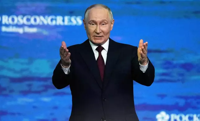 Russian President Vladimir Putin gestures as he arrives to attend a plenary session at the St. Petersburg International Economic Forum in St. Petersburg, Russia, on Friday, June 5, 2026. (AP Photo/Dmitri Lovetsky)