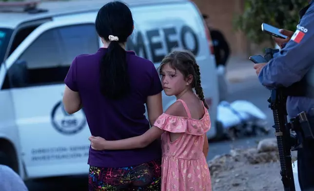 FILE - Relatives of a victim of a fatal armed attack look on as forensic workers investigate the scene, in Culiacán, Sinaloa state, Mexico, April 26, 2026. (AP Photo/Marco Ugarte, File)