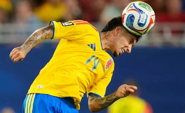 Colombia's Gustavo Puerta (14) heads the ball during the World Cup Group K soccer match between Colombia and Portugal in Miami Gardens, Fla., Saturday, June 27, 2026. (AP Photo/Rebecca Blackwell)
