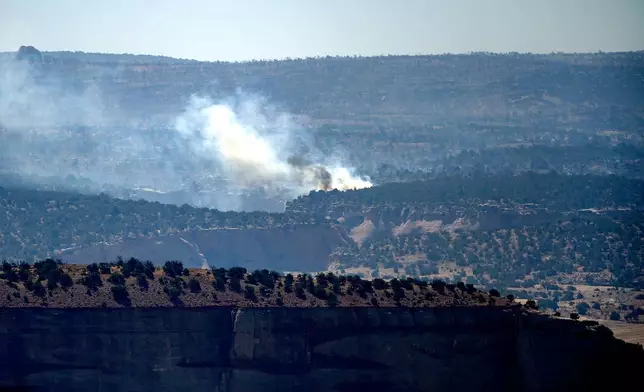 Smoke rises from the Snyder Fire burning near Thompson Springs, Utah, on Sunday, June 28, 2026. (AP Photo/Noah Berger)