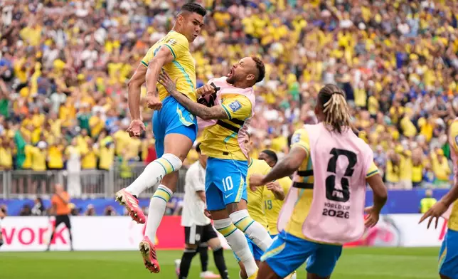 Brazil's Casemiro (5), left, celebrates after scoring his side's first goal during the World Cup round of 32 soccer match between Brazil and Japan in Houston, Monday, June 29, 2026. (AP Photo/Ashley Landis)