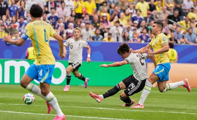 Japan's Kaishu Sano (24) scores the opening goal of his team during the World Cup round of 32 soccer match between Brazil and Japan in Houston, Monday, June 29, 2026. (AP Photo/Ashley Landis)