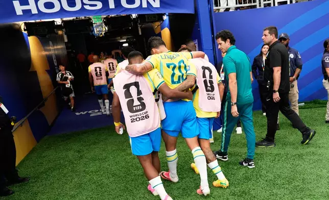 Brazil's Lucas Paqueta (20) is assisted at the half time during the World Cup round of 32 soccer match between Brazil and Japan in Houston, Monday, June 29, 2026. (AP Photo/David J. Phillip)