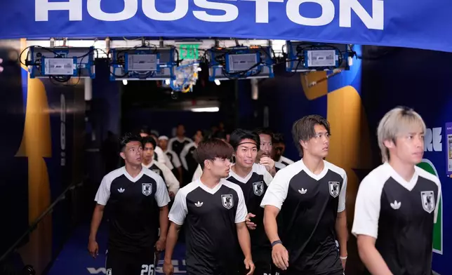 Japan players arrive for the warm up before the World Cup round of 32 soccer match between Brazil and Japan in Houston, Monday, June 29, 2026. (AP Photo/David J. Phillip)