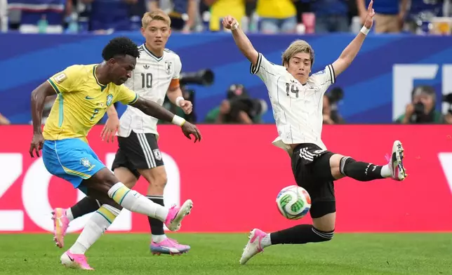 Brazil's Vinicius Junior (7) kicks the ball as Japan's Junya Ito (14) tries to stop him during the World Cup round of 32 soccer match between Brazil and Japan in Houston, on Monday, June 29, 2026. (AP Photo/Eric Gay)