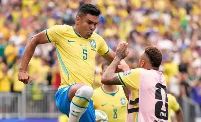 Brazil's Casemiro (5), left, celebrates after scoring his side's first goal during the World Cup round of 32 soccer match between Brazil and Japan in Houston, Monday, June 29, 2026. (AP Photo/Ashley Landis)