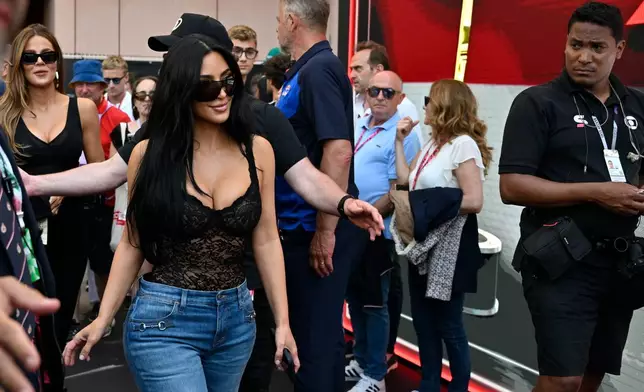 Kim Kardashian walks in the paddock the qualifying session for the Monaco F1 Grand Prix, at the Monaco racetrack, Saturday, June 6, 2026. (AP Photo/Philippe Magoni)