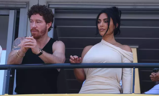 Kim Kardashian, right, attends wth former snowboarder Shaun White during the Formula One Monaco Grand Prix race at the Monaco racetrack, Sunday, June 7, 2026. (Yves Herman, Pool Photo via AP)