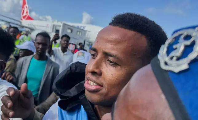 Referee Omar Artan, who was denied entry to the United States, is welcomed by supporters upon his arrival in Mogadishu, Somalia, Wednesday, June 10, 2026. (AP Photo/Farah Abdi Warsameh)