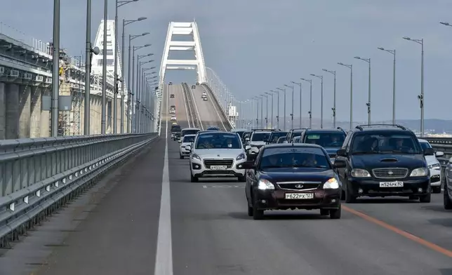 FILE - Cars and other vehicles drive on the Kerch Bridge connecting the Russian mainland and the Crimean Peninsula on Thursday, Feb. 23, 2023. (AP Photo, File)