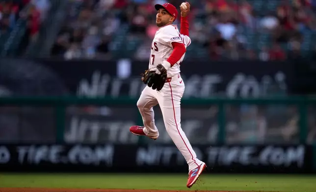 Los Angeles Angels second baseman Nick Madrigal throws out Colorado Rockies' Jake McCarthy at first during the third inning of a baseball game Wednesday, June 3, 2026, in Anaheim, Calif. (AP Photo/Mark J. Terrill)