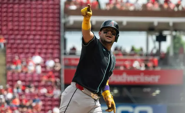 Arizona Diamondbacks' Gabriel Moreno gestures after hitting a home run in the eighth inning of a baseball game against the Cincinnati Reds, Sunday, June 14, 2026, in Cincinnati. (AP Photo/Michael Swensen)
