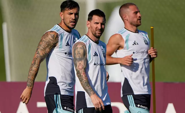 Argentina's Leandro Paredes, left, Lionel Messi, center, and Alexis Mac Allister train for the World Cup soccer tournament Wednesday, June 24, 2026, in Kansas City, Kan. (AP Photo/Charlie Riedel)