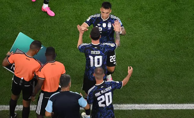 Argentina's Lautaro Martinez (22) is substituted by Argentina's Lionel Messi (10) during the World Cup Group J soccer match between Jordan and Argentina in Arlington, Texas, near Dallas, Saturday, June 27, 2026. (AP Photo/Jessica Tobias)
