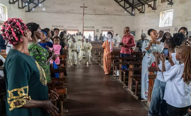 Altar boys arrive at a chapel during a wedding ceremony amid an Ebola outbreak in Ituri Province in Bunia, Congo, Saturday, June 6, 2026. (AP Photo/Moses Sawasawa)