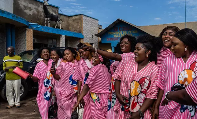 Wedding guests cheer at a wedding ceremony amid an Ebola outbreak in Ituri Province in Bunia, Congo, Saturday, June 6, 2026. 2026. (AP Photo/Moses Sawasawa)