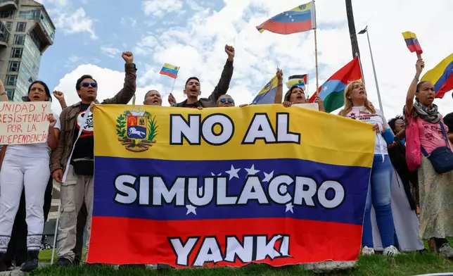 Government supporters protest against a U.S. emergency and air evacuation drill conducted at the U.S. Embassy in Caracas, Venezuela, Saturday, May 23, 2026. (AP Photo/Pedro Mattey)