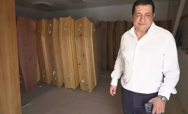Zouhaeir Hertelli, a mortuary and funeral service director, walks out of his coffin storeroom near Paris’ Orly airport on Sunday, June 28, 2026. (AP Photo/John Leicester)