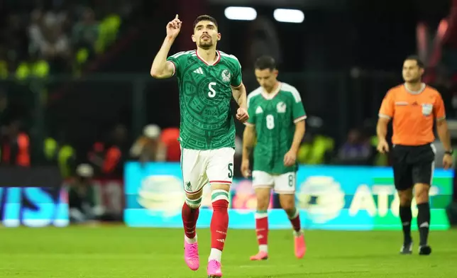 Mexico's Johan Vásquez (5) reacts after scoring his side's first goal against Serbia during an international friendly soccer match in Toluca, Mexico, Thursday, June 4, 2026. (AP Photo/Moises Castillo)