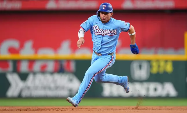 Texas Rangers' Alejandro Osuna runs the bases before scoring on a double by Kyle Higashioka during the first inning of a baseball game against the Kansas City Royals, Sunday, May 31, 2026, in Arlington. (AP Photo/Julio Cortez)