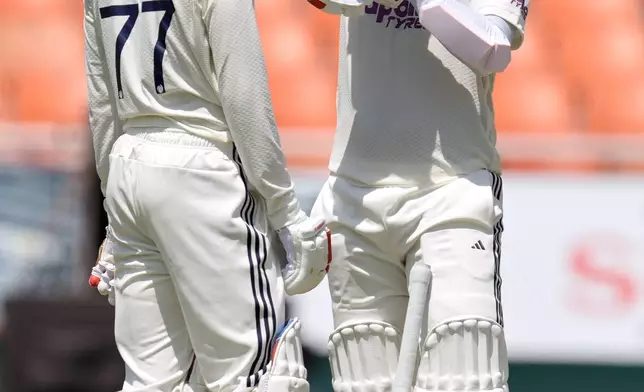India's KL Rahul, right, puts on his helmet as captain Shubman Gill looks on during a break in play on day one of the cricket test match between Afghanistan and India in New Chandigarh, India, Saturday, June 6, 2026. (AP Photo/Ashwini Bhatia)