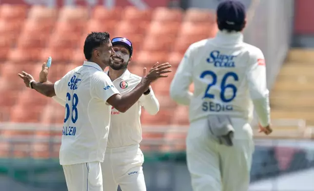 Afghanistan's Mohammad Saleem, left, celebrates the wicket of India's Yashasvi Jaiswal on day one of the cricket test match between Afghanistan and India in New Chandigarh, India, Saturday, June 6, 2026. (AP Photo/Ashwini Bhatia)
