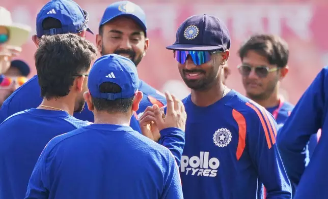India's Manav Suthar is congratulated by teammates as he makes his test debut before the start of play on day one of the cricket test match between Afghanistan and India in New Chandigarh, India, Saturday, June 6, 2026. (AP Photo/Ashwini Bhatia)
