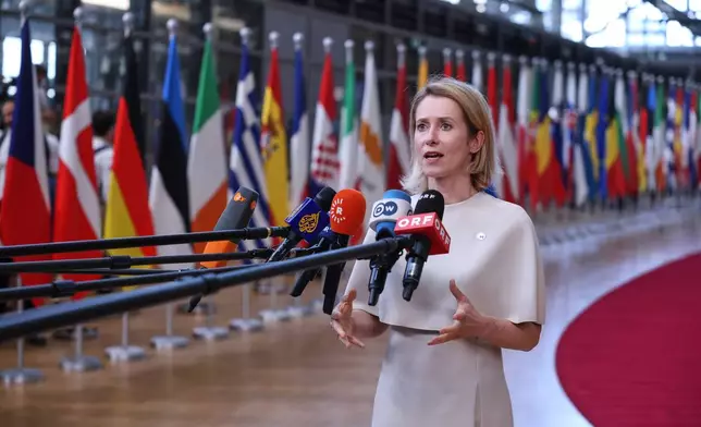 European Union foreign policy chief Kaja Kallas talks to journalists as she arrives for the EU summit in Brussels, Thursday, June 18, 2026. (AP Photo/Omar Havana)