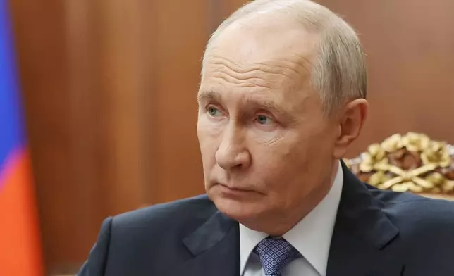 Russian President Vladimir Putin speaks with Sergei Menyailo, the North Ossetia-Alania Republic Head, during their meeting at the Kremlin in Moscow, Tuesday, June 16, 2026. (Vyacheslav Prokofyev, Sputnik, Kremlin Pool Photo via AP)