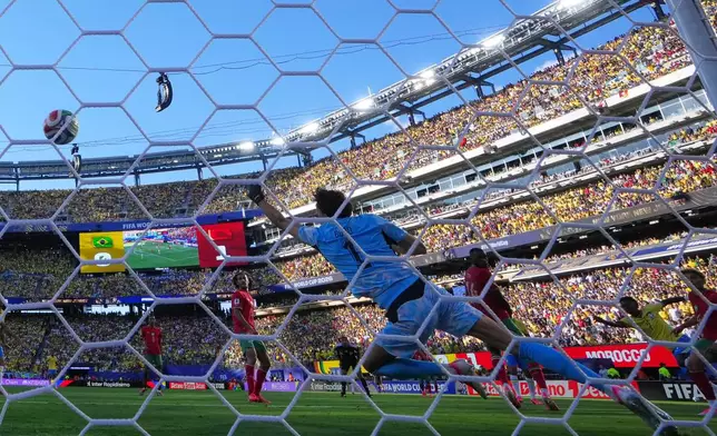 Brazil's Vinicius Junior (7), second right, scores their first goal during the World Cup Group C soccer match between Brazil and Morocco in East Rutherford, N.J., near New York, Saturday, June 13, 2026. (AP Photo/Petr David Josek)