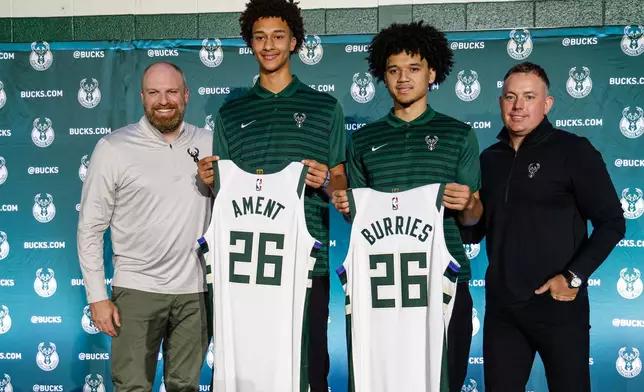 First round NBA draft picks of the Milwaukee Bucks, Nate Ament, second eft and Brayden Burries pose for photographs with Head coach Taylor Jenkins, left and General manager Jon Horst, right, at a Boys and Girls club in Milwaukee, Thursday, June 25, 2026. (AP Photo/Jeffrey Phelps)