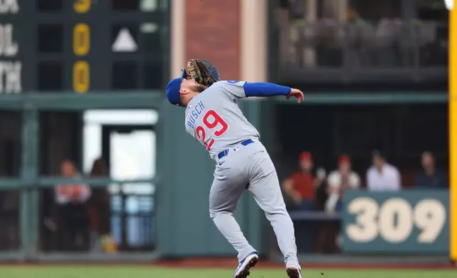 Chicago Cubs first baseman Michael Busch catches a pop fly for the second out of the first inning of a baseball game against the San Francisco Giants Friday, June 12, 2026, in San Francisco, Calif. (AP Photo/Scott Marshall)