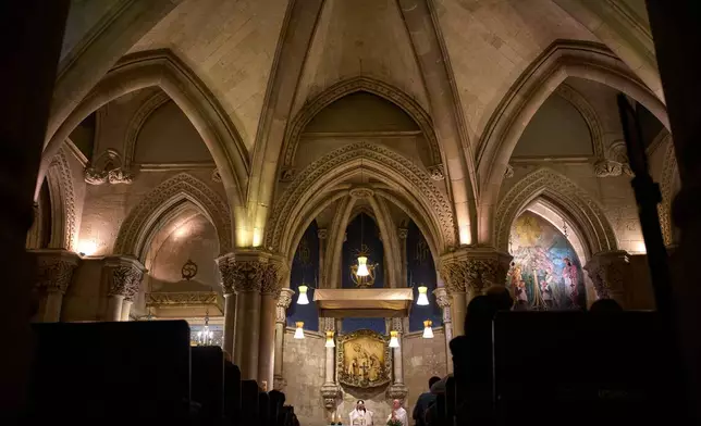 Parishioners attend Mass in the crypt of Antoni Gaudí's Basilica of the Sagrada Familia in Barcelona, Spain, Friday, May 15, 2026 ahead of Pope Leo XIV's visit to the city in June. (AP Photo/Emilio Morenatti)